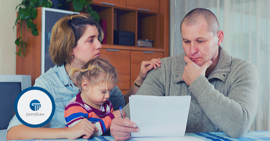 parents and child looking at paper