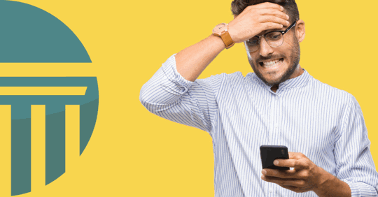 distressed man looking at smartphone